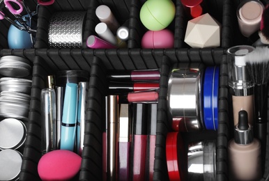 Photo of Stylish case with makeup products and beauty accessories, closeup