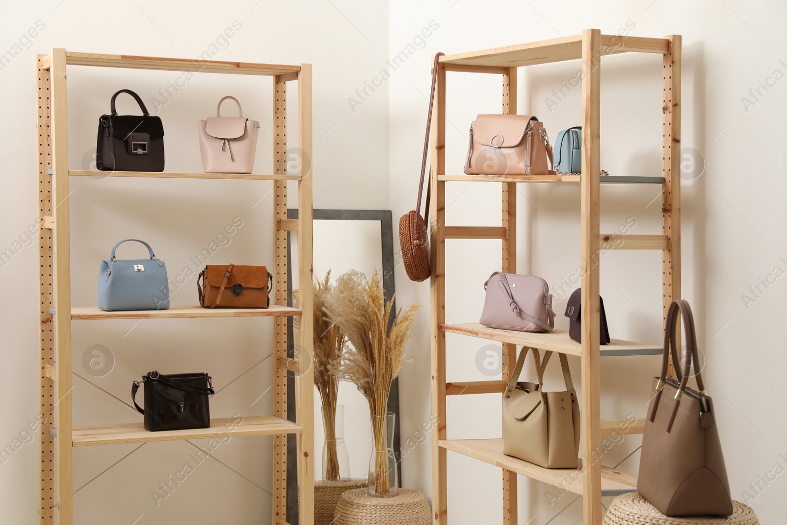 Photo of Stylish woman's bags on shelves in boutique