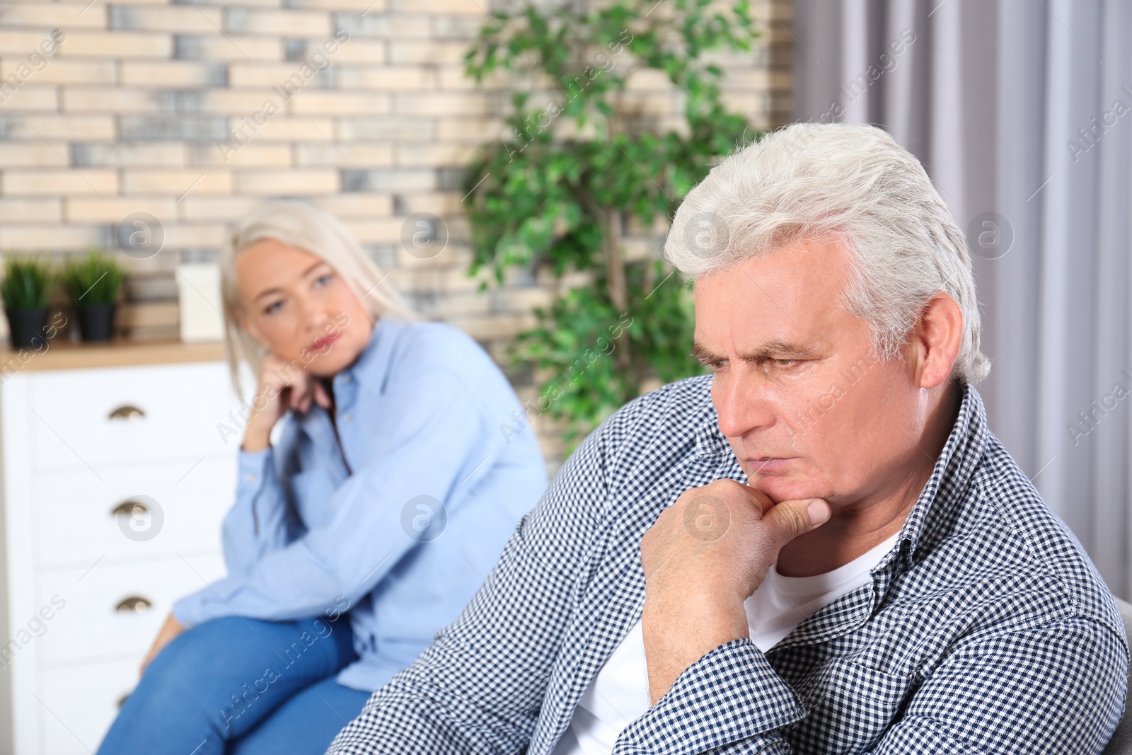 Photo of Mature couple with relationship problems in living room