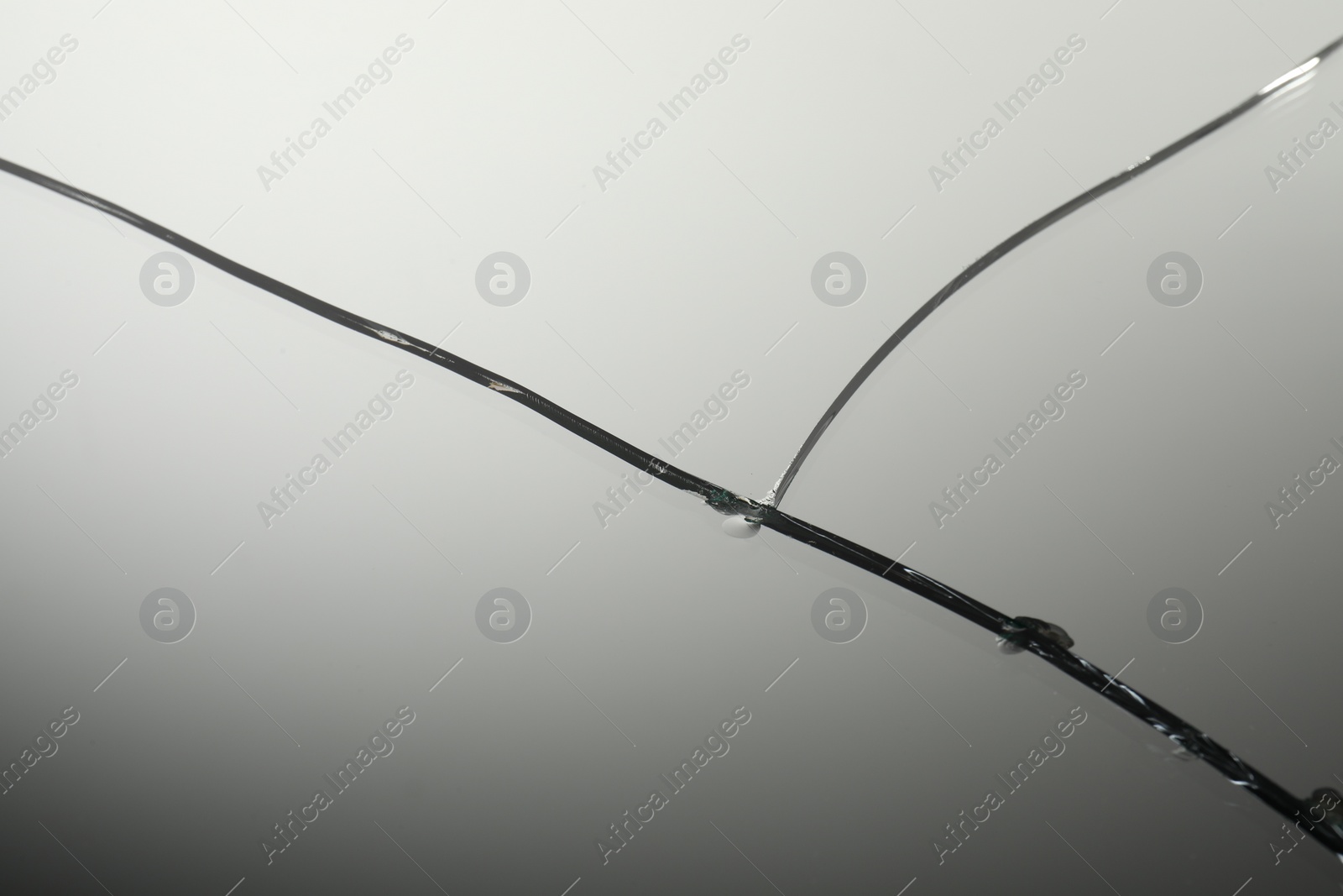 Photo of Broken mirror with large cracks as background, closeup view