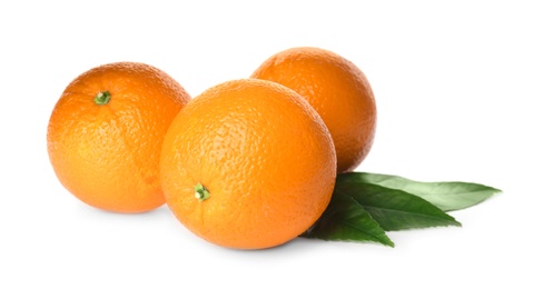 Fresh ripe oranges with green leaves on white background