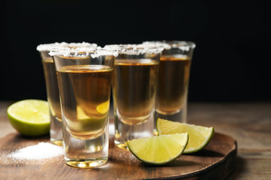 Mexican Tequila shots, lime and salt on wooden table