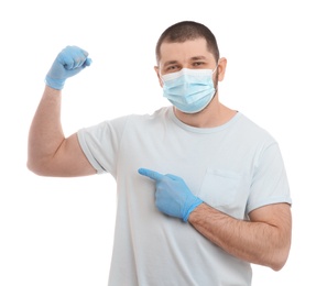 Photo of Man with protective mask and gloves showing muscles on white background. Strong immunity concept