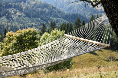 Empty comfortable net hammock in mountains on sunny day