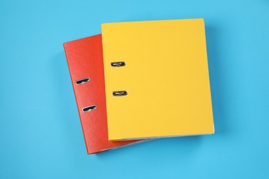Photo of Office folders on light blue background, flat lay