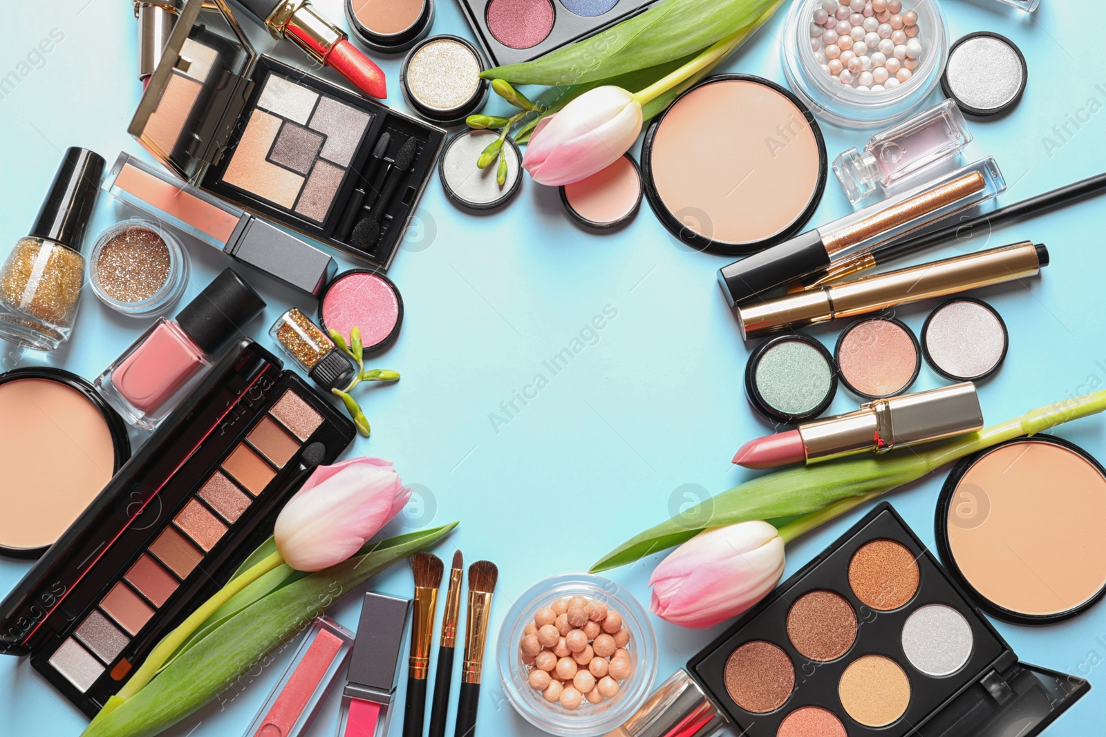 Photo of Different makeup products and flowers on color background, flat lay with space for text