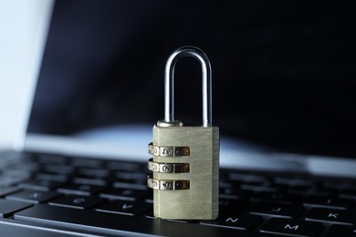 Photo of Cyber security. Padlock on laptop, closeup view