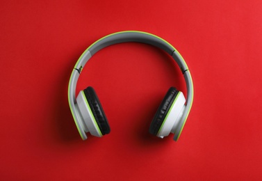 Photo of Wireless headphones on color background, top view