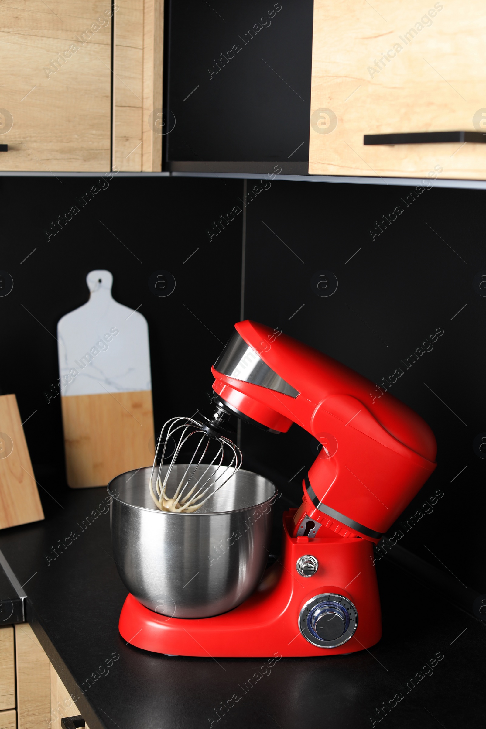 Photo of Modern stand mixer on countertop in kitchen. Home appliance