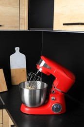 Photo of Modern stand mixer on countertop in kitchen. Home appliance