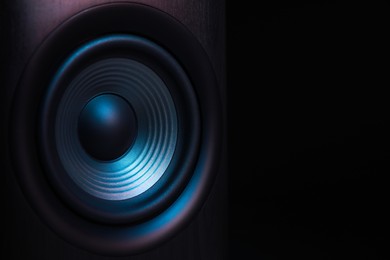 Photo of One sound speaker on black background, closeup. Space for text