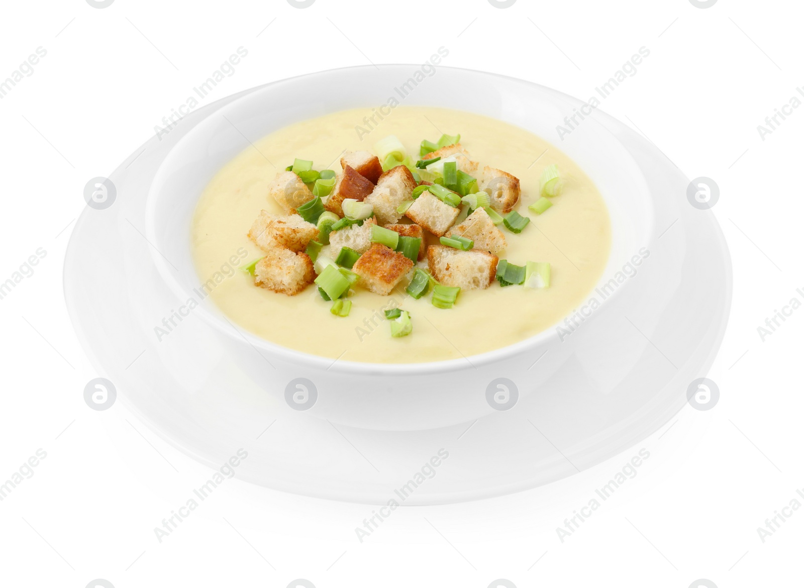 Photo of Tasty potato soup with croutons and green onion in bowl isolated on white