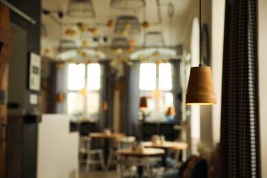 Stylish cafe interior with furniture, blurred view