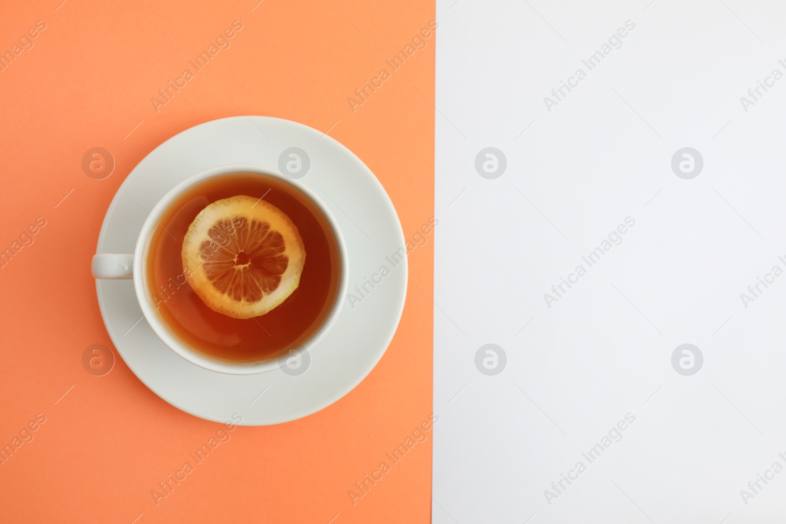 Photo of Cup of tea on color background, top view. Space for text