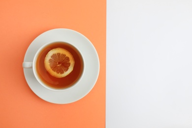 Photo of Cup of tea on color background, top view. Space for text