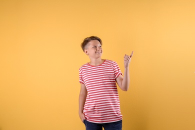 Photo of Teenage boy in casual clothes on color background