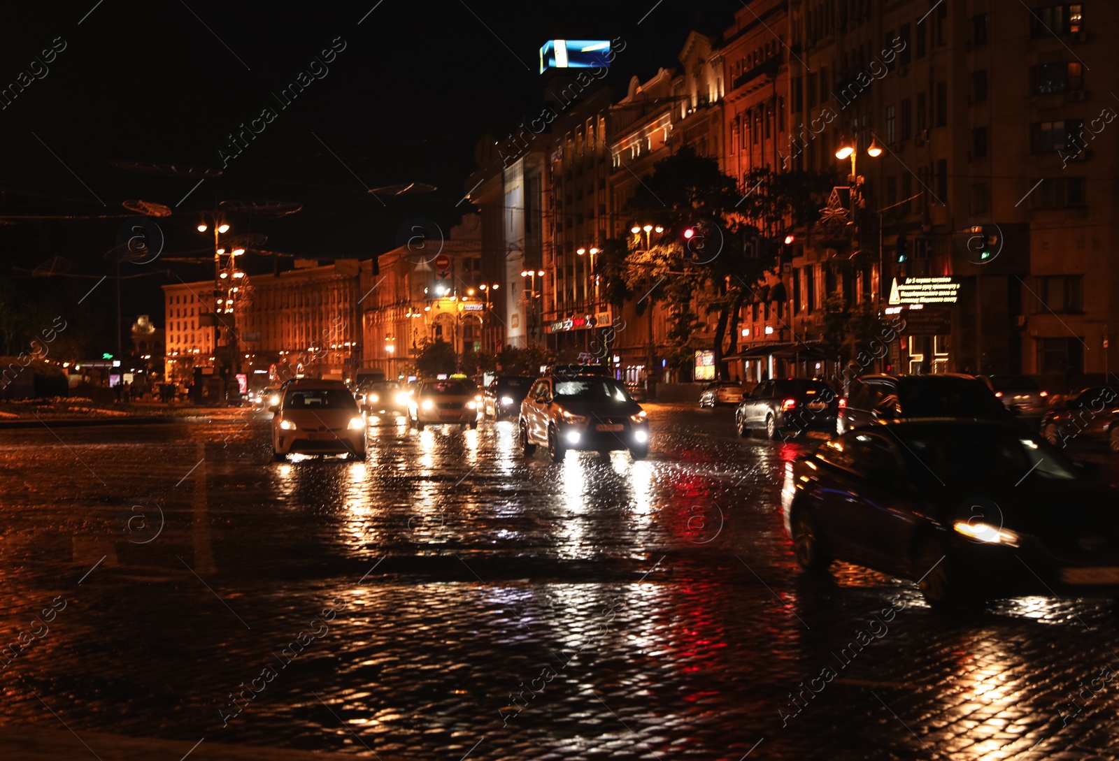 Photo of KYIV, UKRAINE - MAY 21, 2019: Night cityscape with illuminated buildings and street traffic