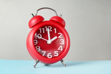 Photo of Alarm clock on table. Time change concept