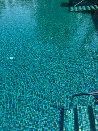 Photo of Metal rail and steps in outdoor swimming pool