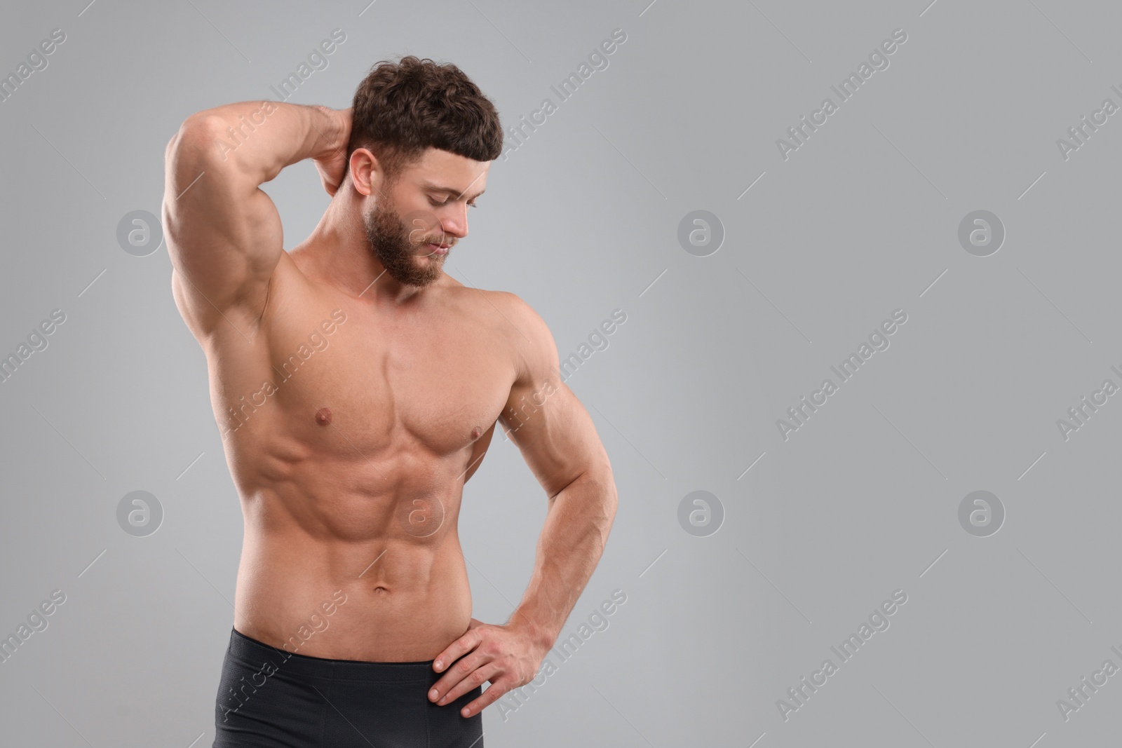 Photo of Handsome muscular man on light grey background, space for text. Sexy body