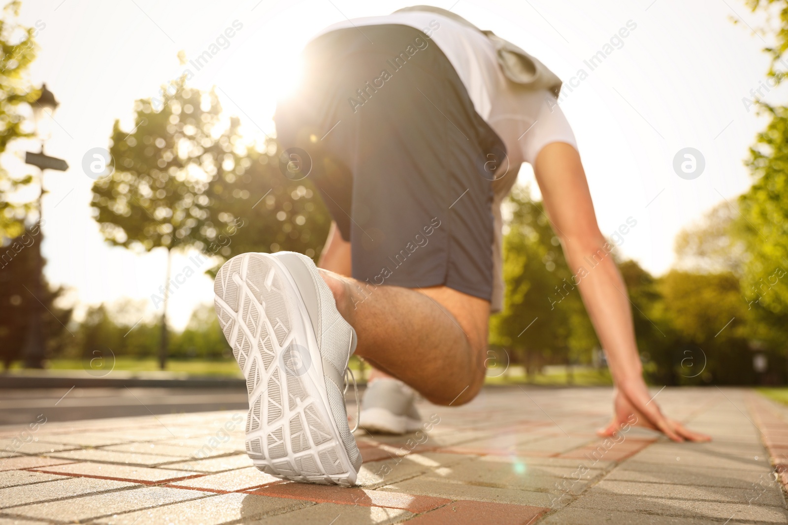 Photo of Man in fitness clothes ready for running outdoors, low angle view