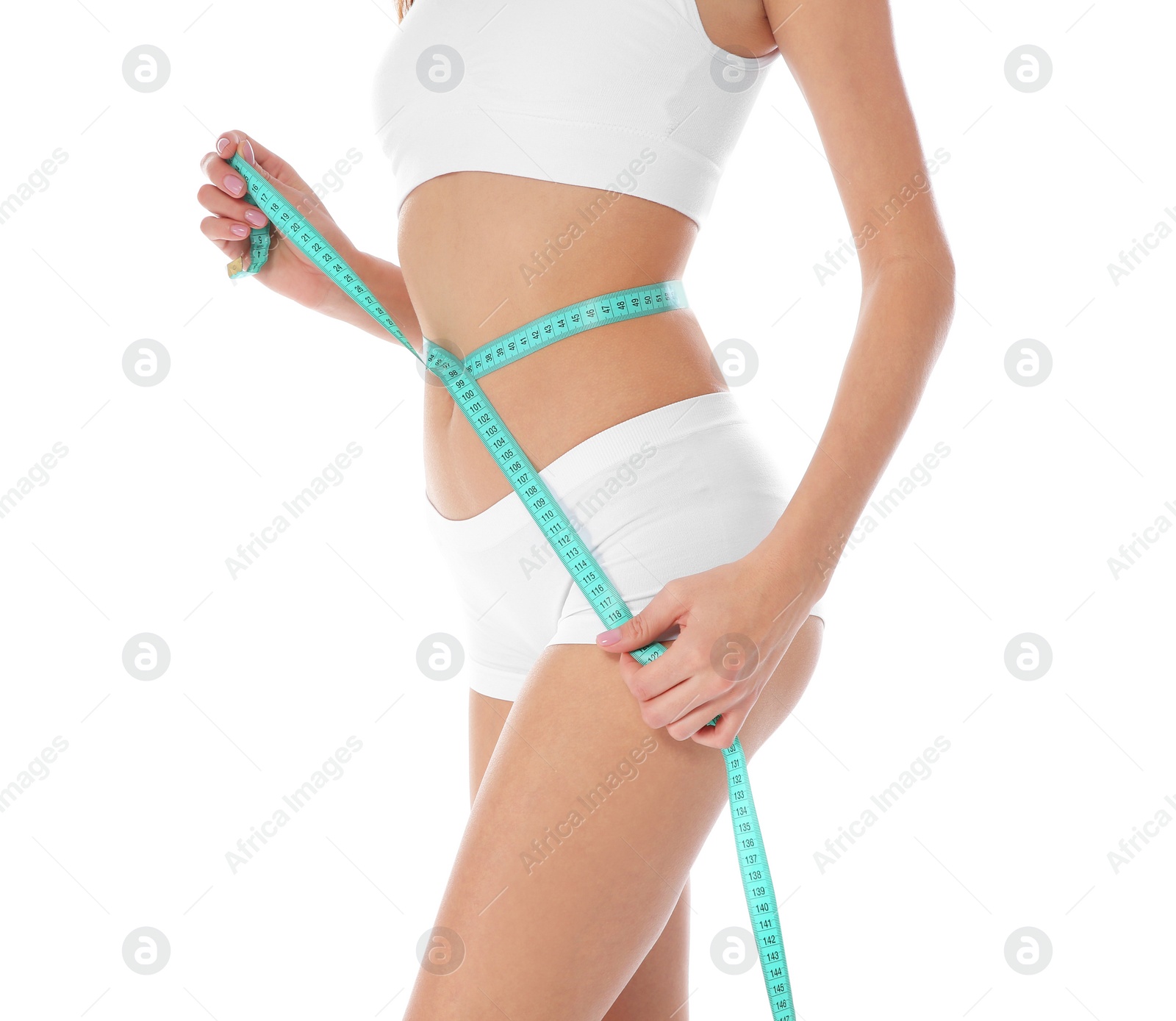 Photo of Slim woman measuring her waist on white background, closeup. Weight loss