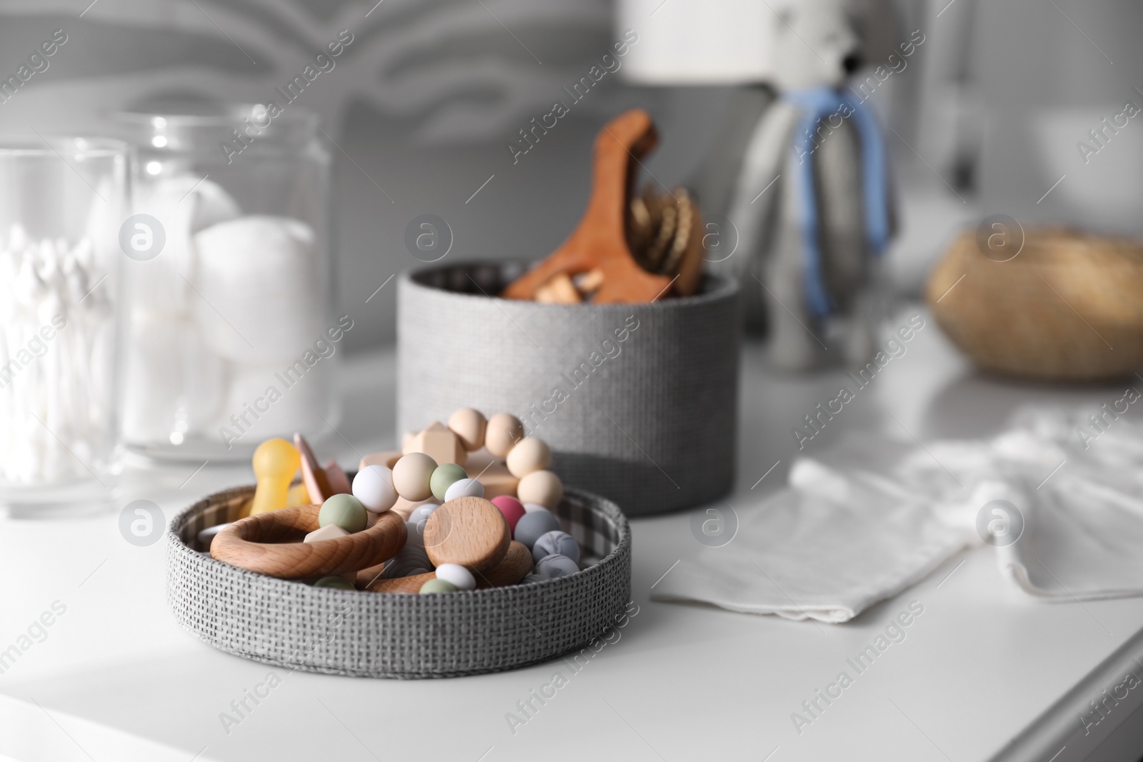 Photo of Baby accessories and toys on table in room