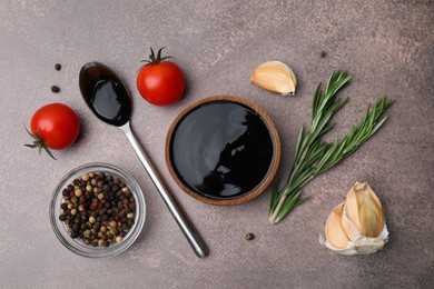 Organic balsamic vinegar and cooking ingredients on grey table, flat lay