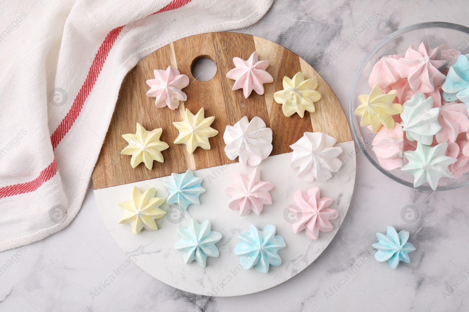 Photo of Tray with tasty meringue cookies on white marble table, top view