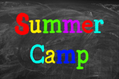 Image of Colorful words SUMMER CAMP written on blackboard