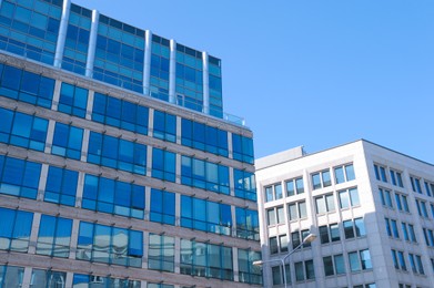 Low angle view of modern buildings on sunny day