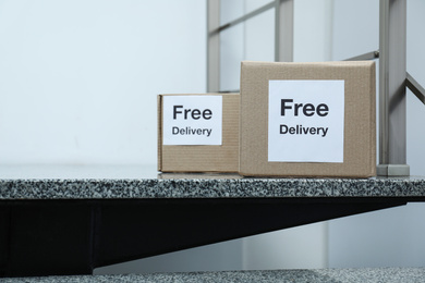 Photo of Parcels with stickers Free Delivery on stairs. Courier service