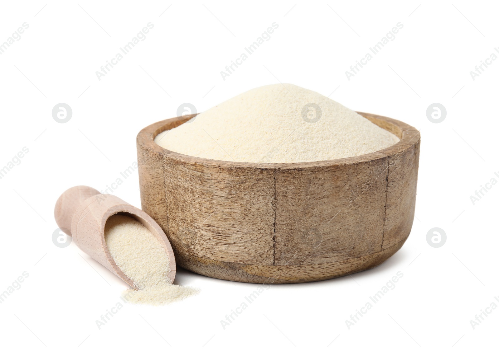 Photo of Uncooked organic semolina in wooden bowl and scoop isolated on white