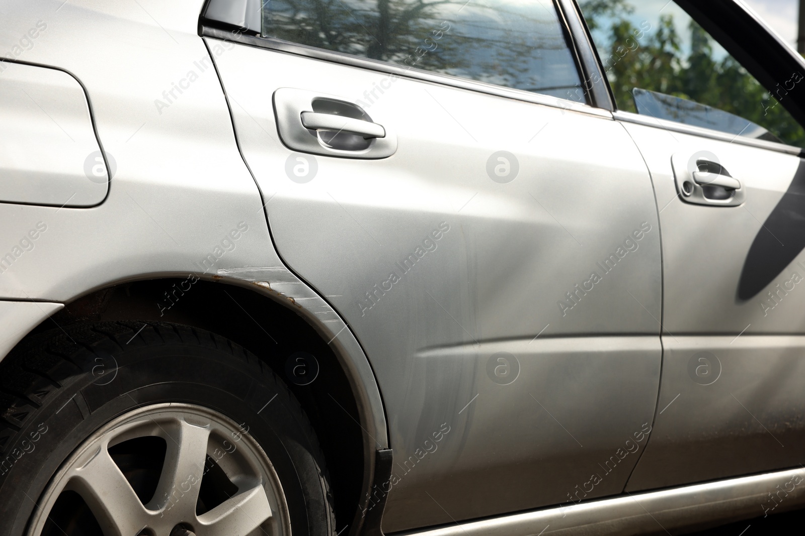 Photo of Modern gray car with scratch outdoors, closeup