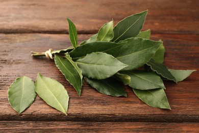 Aromatic fresh bay leaves on wooden table
