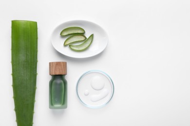 Photo of Cosmetic products and cut aloe leaves on white background, flat lay. Space for text