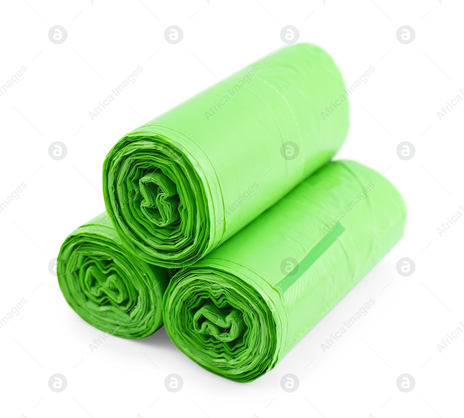 Photo of Rolls of light green garbage bags isolated on white