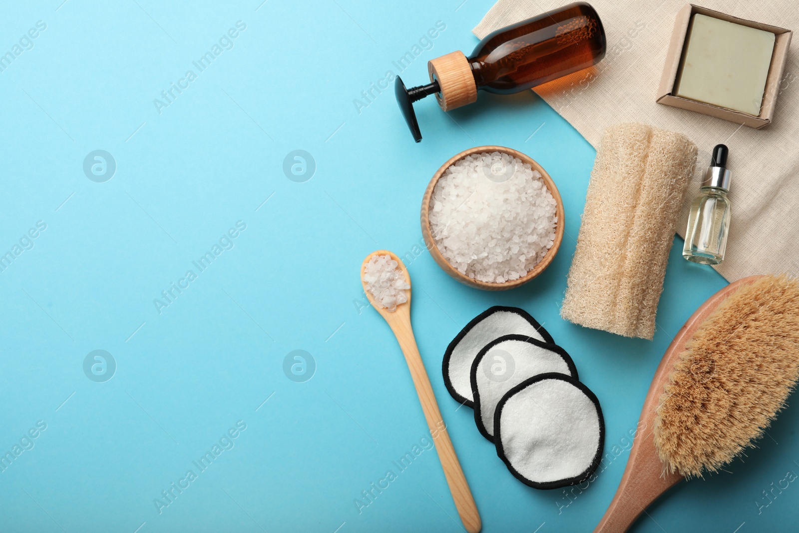 Photo of Flat lay composition with eco friendly products on light blue background, space for text