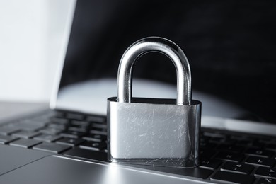 Photo of Cyber security. Padlock on laptop, closeup view