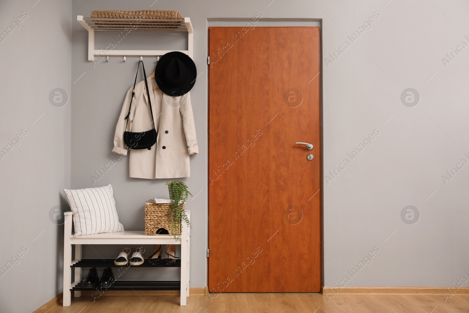 Photo of Modern hallway interior with stylish furniture near wooden door