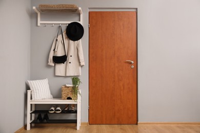 Photo of Modern hallway interior with stylish furniture near wooden door