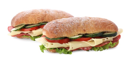 Photo of Delicious sandwiches with fresh vegetables, cheese and salami isolated on white