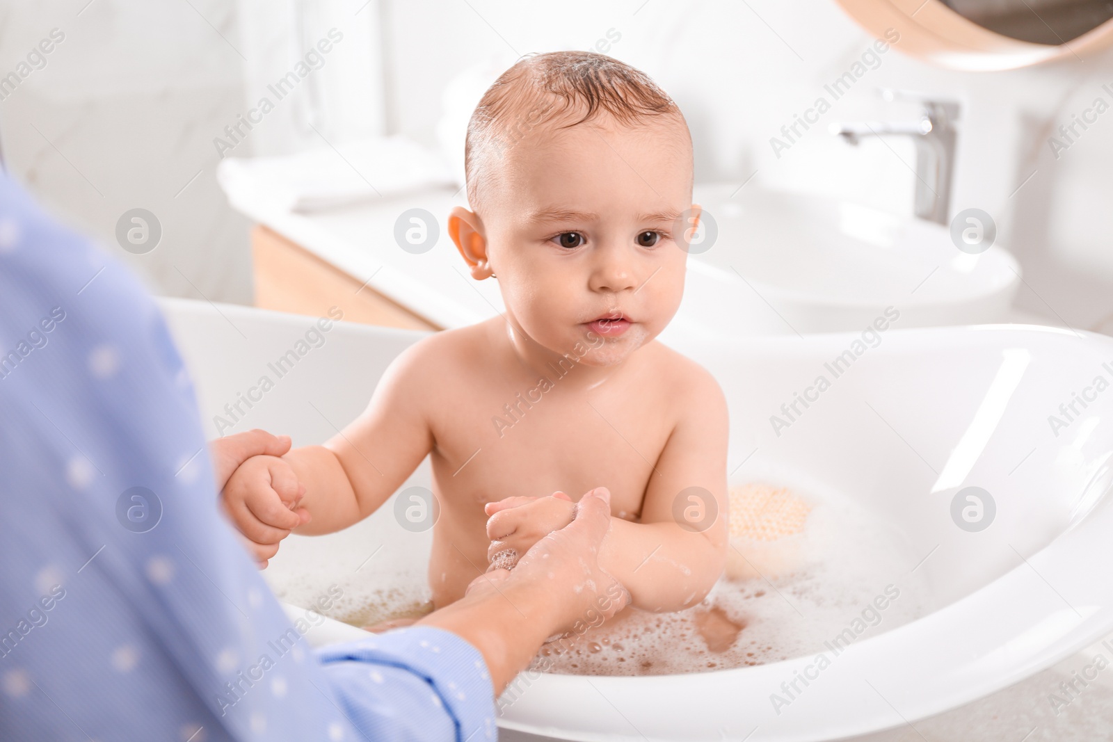 Photo of Mother with her little baby in bathroom