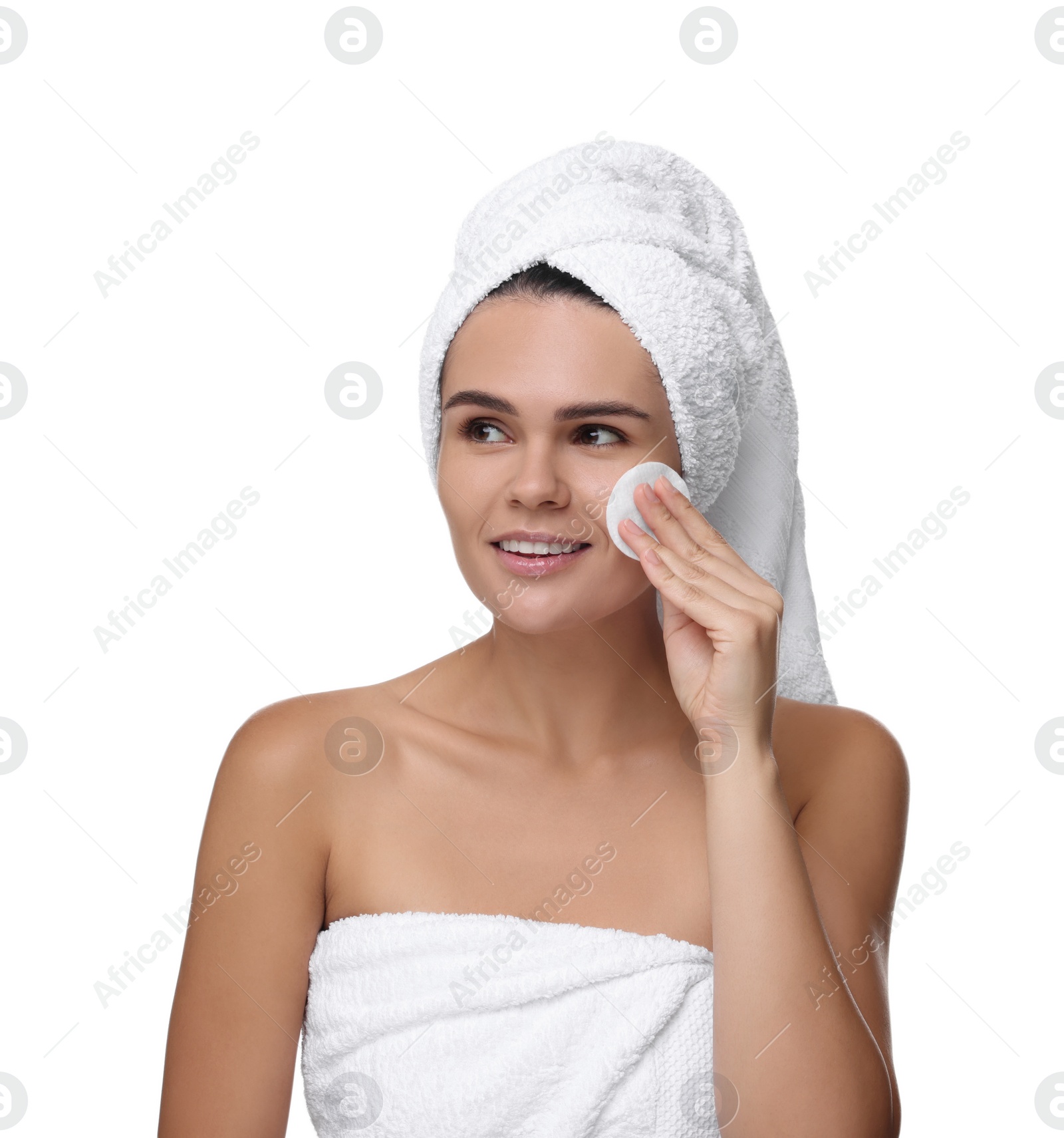 Photo of Young woman cleaning her face with cotton pad on white background