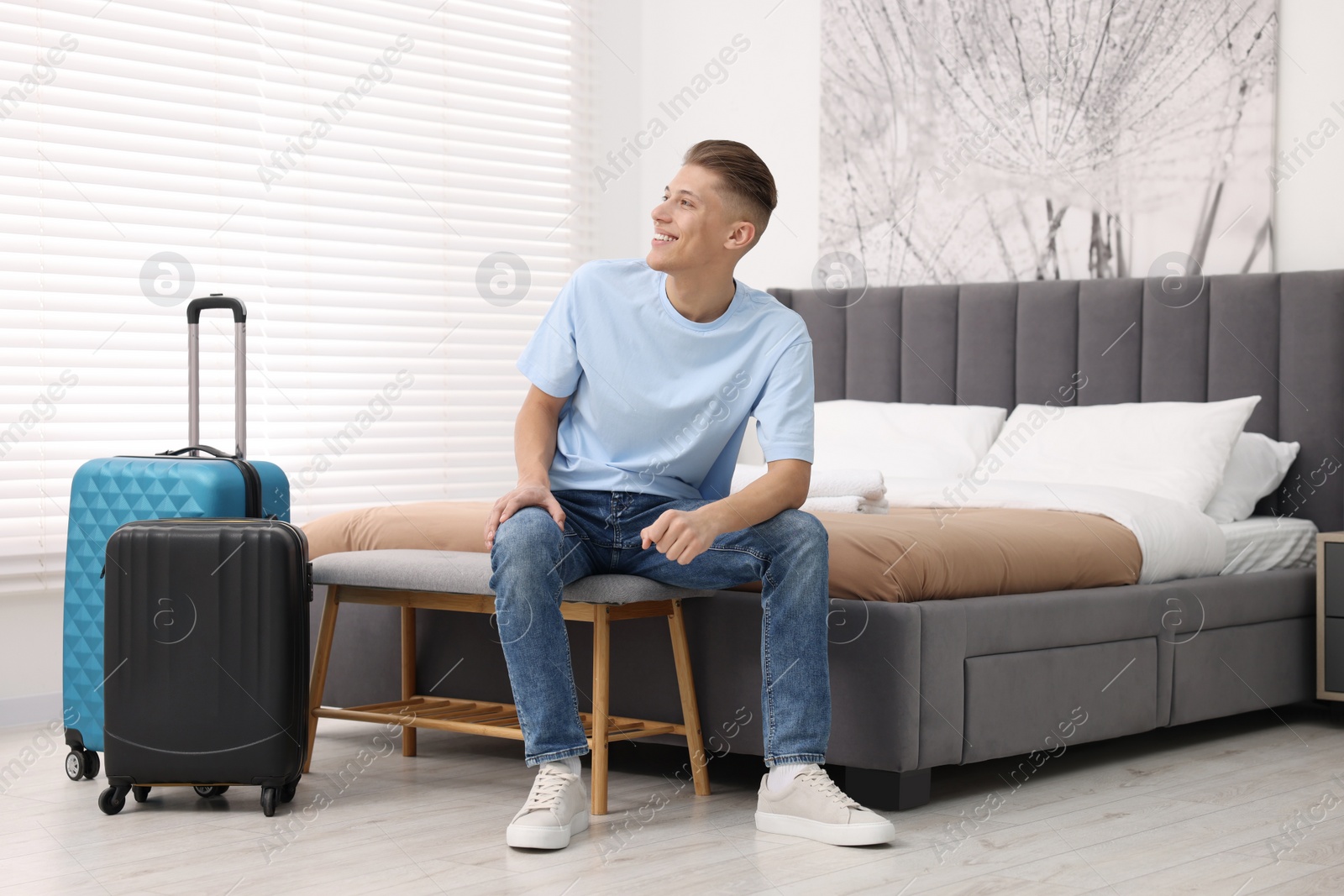 Photo of Smiling guest relaxing in stylish hotel room