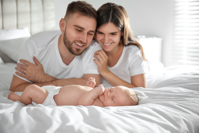 Happy couple with their newborn baby at home