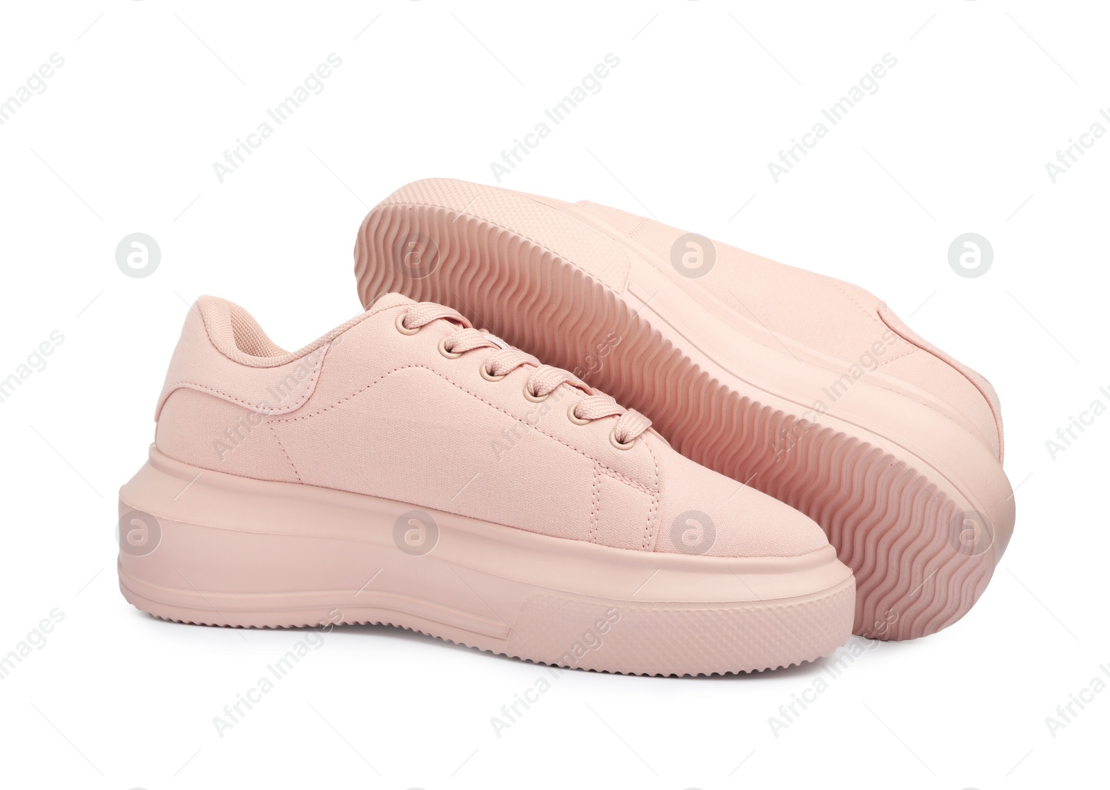 Photo of Pair of comfortable pink shoes on white background