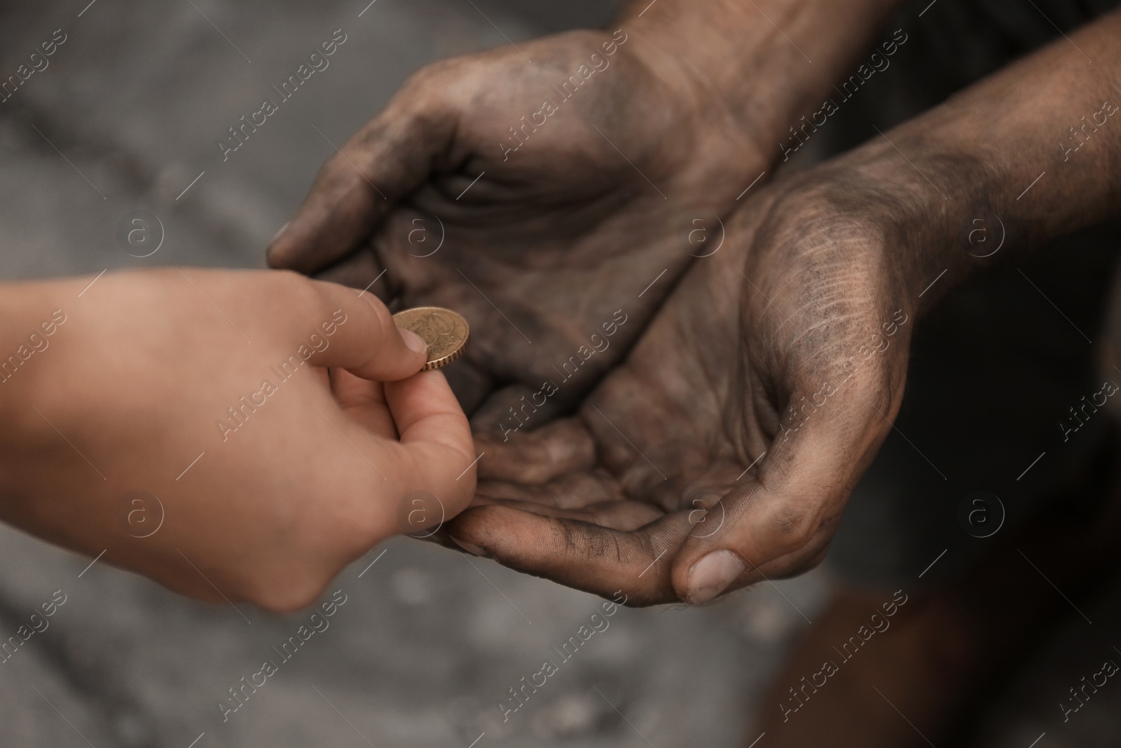 Photo of Woman giving poor homeless person money outdoors, closeup