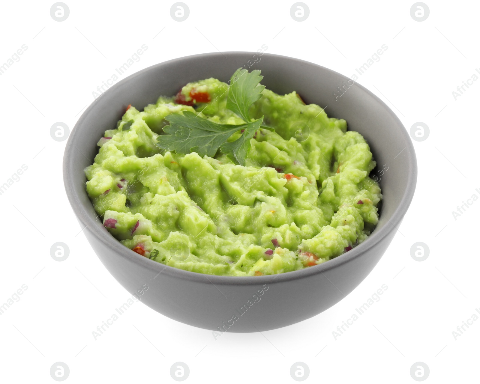 Photo of Bowl of delicious guacamole with parsley isolated on white