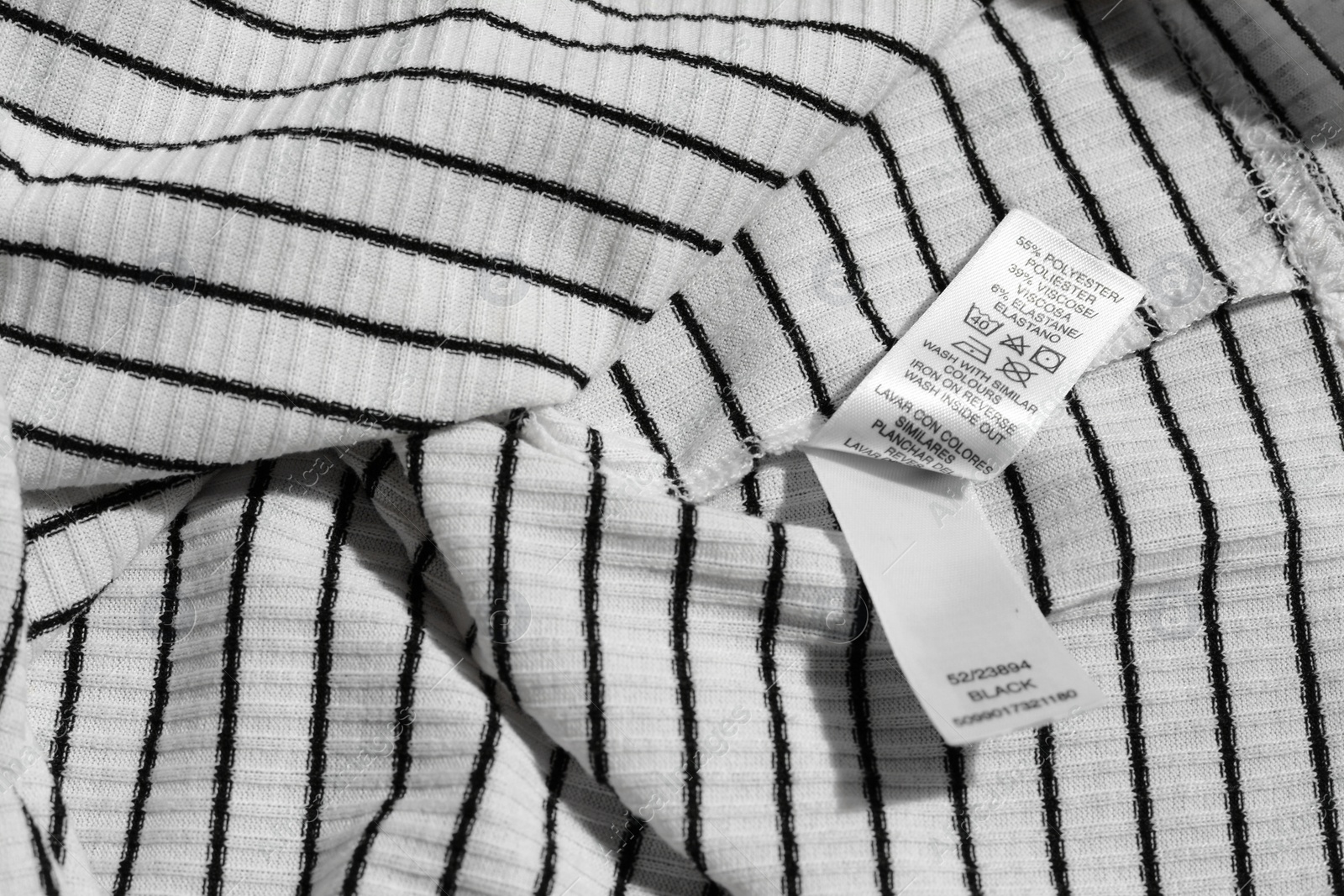 Photo of Clothing label on striped garment, top view